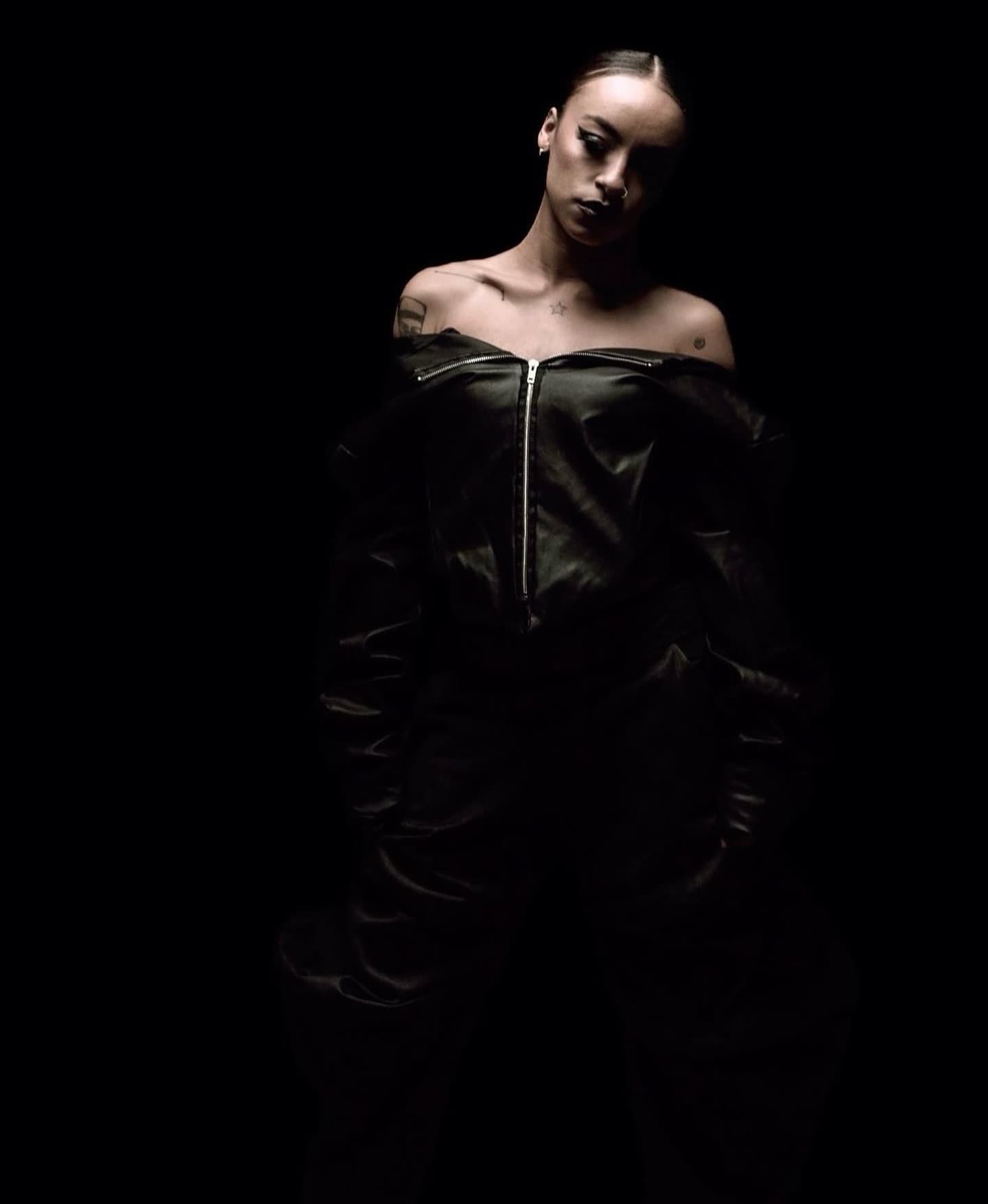 Off-the-shoulder leather bodice with a smoked-out graphic cat eye