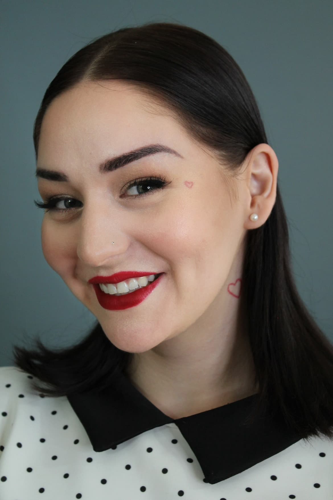 Classic red-lip beauty portrait with winged lash and a flawless satin complexion